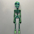 3D printed white skull refrigerator magnet on a metal surface, showing its 18cm height.