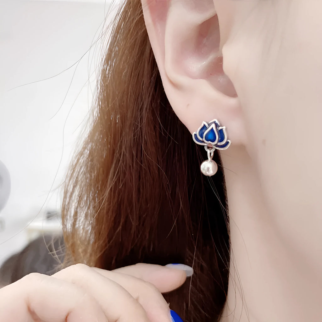 Blue lotus and seedpod earrings with dangling tassels on silver alloy posts.