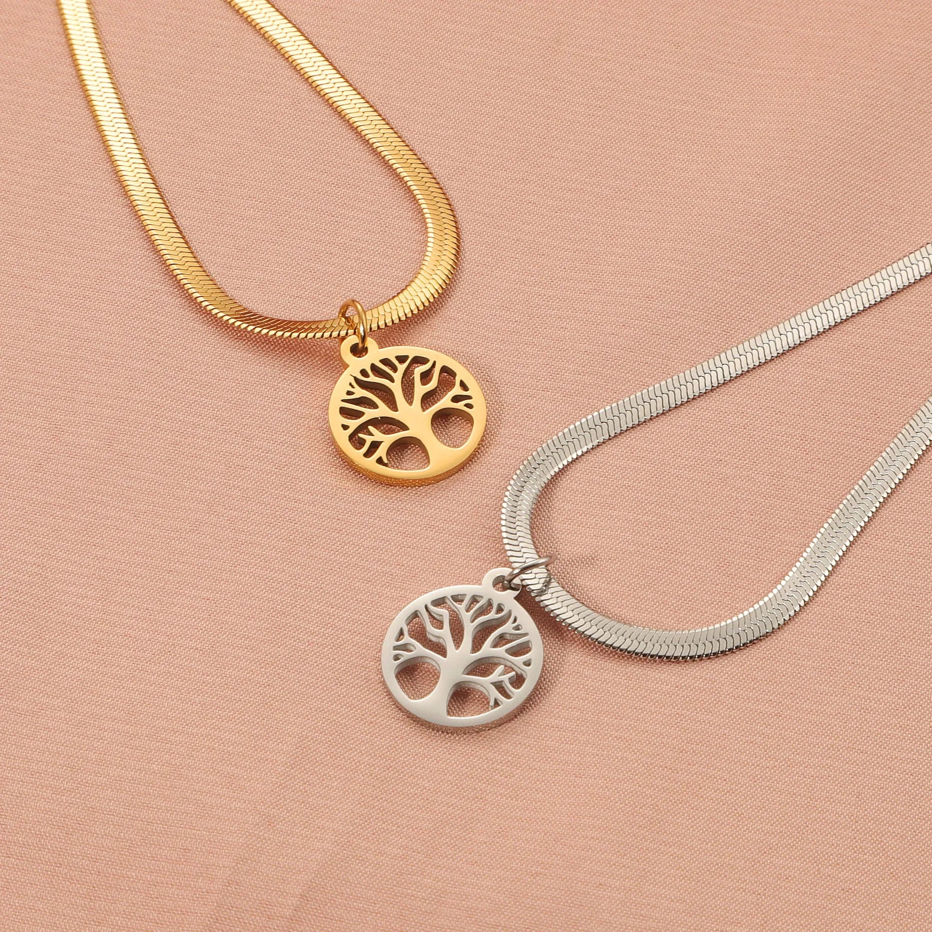Gold or steel colour stainless steel necklace with a tree pendant on a snake bone chain.