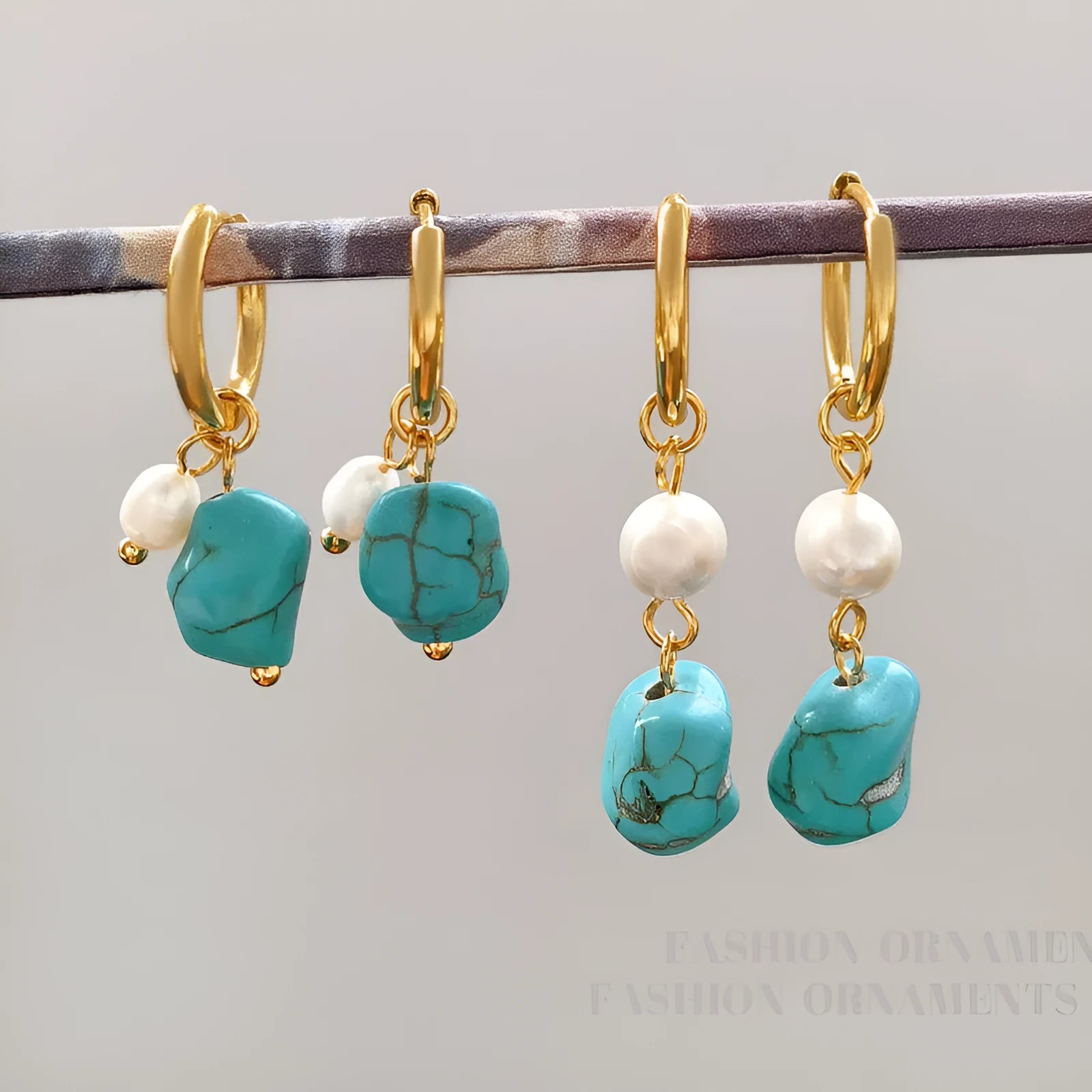 A pair of geometric copper clip-on earrings featuring irregular blue-green turquoise stones and white cultured pearls.