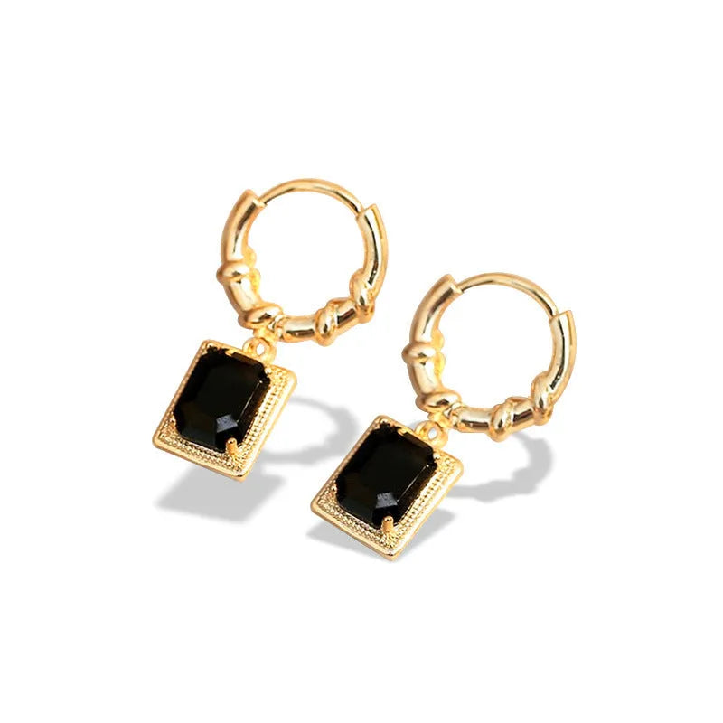Close-up of black geometric cubic zirconia earrings with a quadrilateral design and butterfly clutch backs.