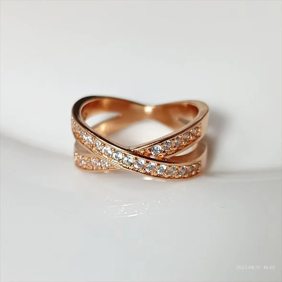 Simple silver and rose gold metal rings with micro-inlaid zircon detailing on a copper band.