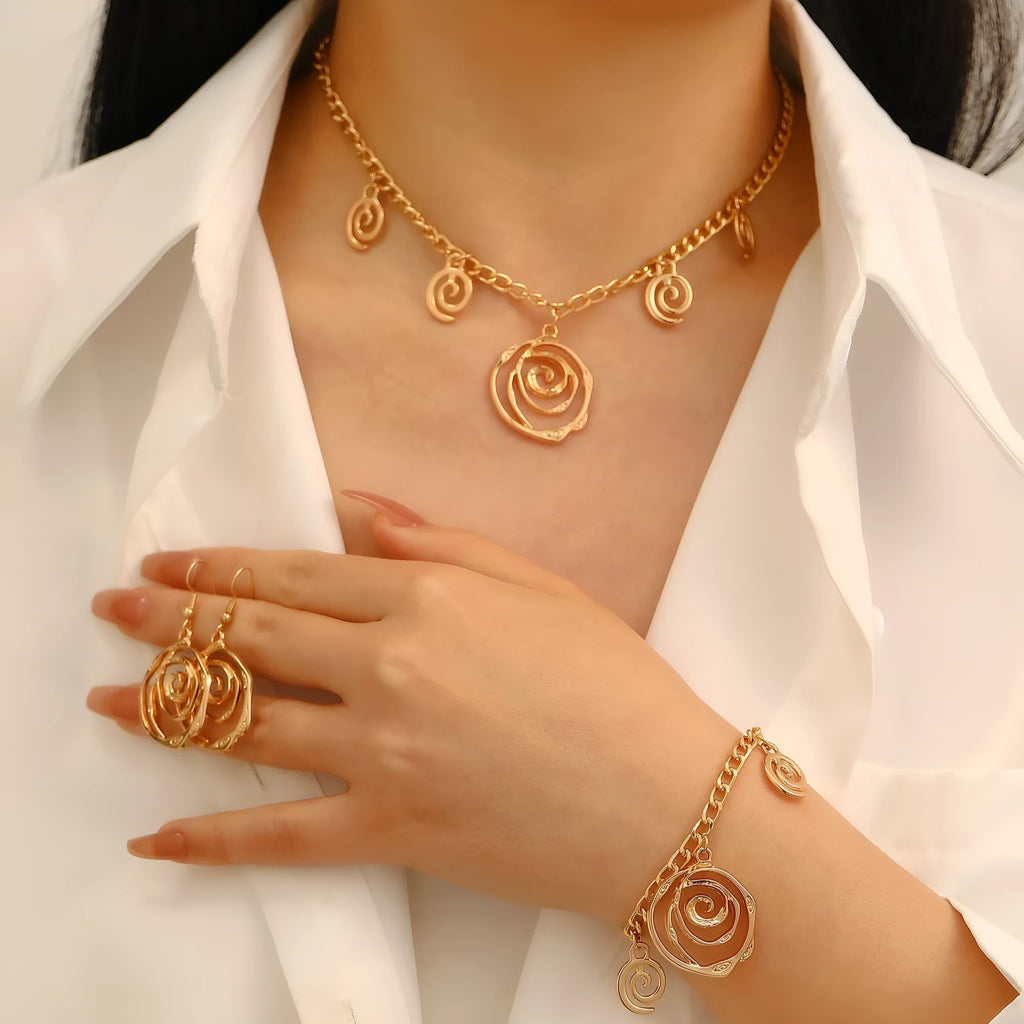 Spiral donut jewellery set showing necklace, bracelet and ear hooks with geometric circle designs in gold finish