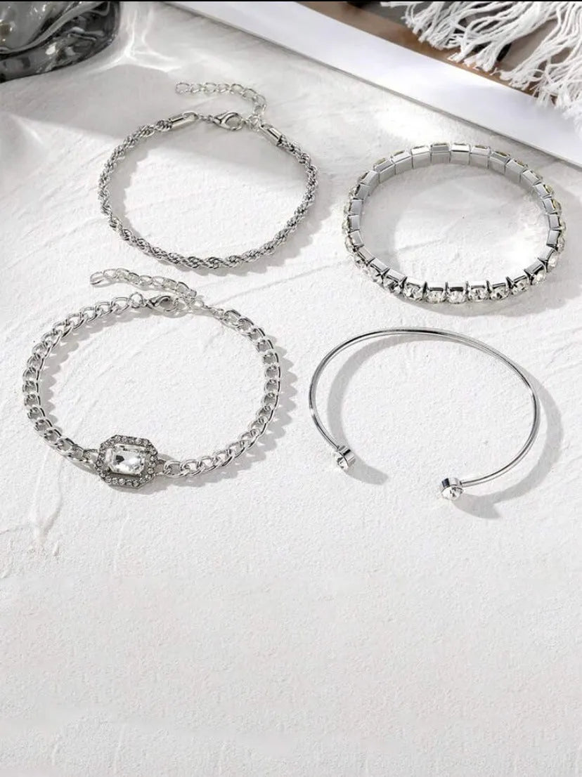 Retro geometric alloy bracelet four-piece set with square diamond details in gold and silver colours.