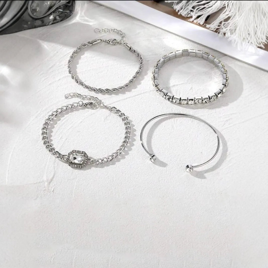Retro geometric alloy bracelet four-piece set with square diamond details in gold and silver colours.