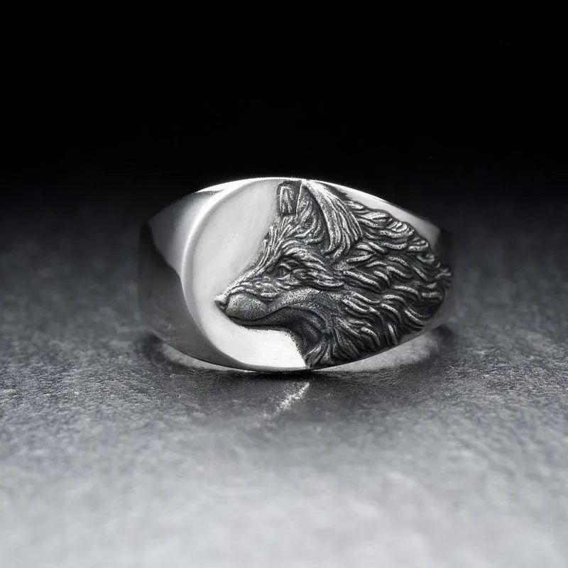 Men's silver geometric wolf head ring made from alloy on a grey background.