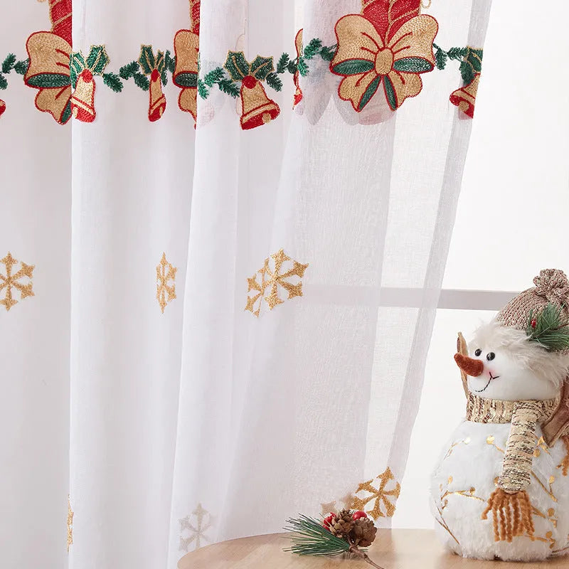 Pair of red and white American Christmas curtains with embroidered snowflake design hung on a window.