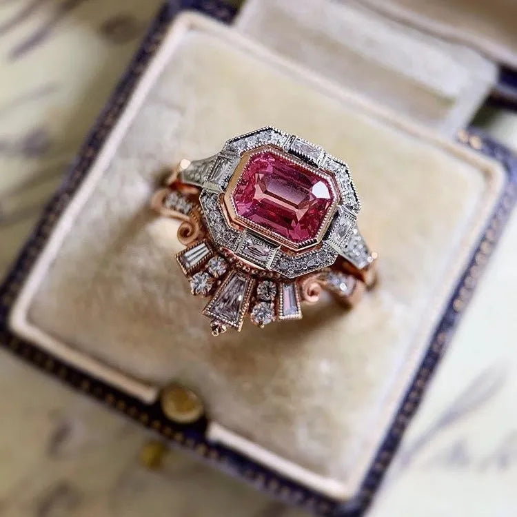 Retro style rose gold women's ring with a geometric shape and central ruby stone.