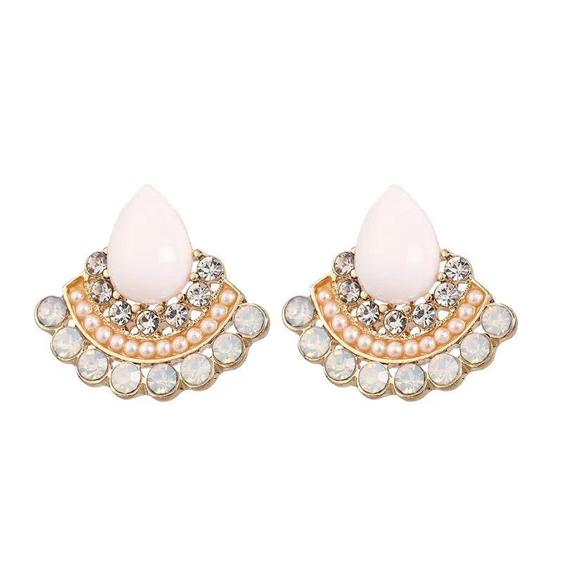 A pair of silver retro fan-shaped stud earrings with rhinestone details on a geometric design.