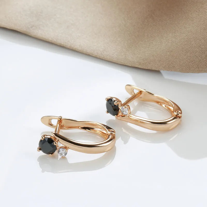 Gold geometric drop earrings with black agate stone accents on copper base