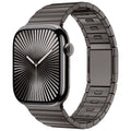 Stainless steel magnetic buckle watch strap for Apple Watch in silver colour on a grey background