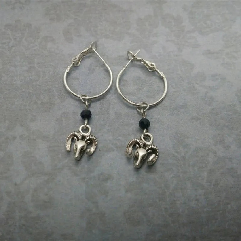 Silver round ring earrings with a Tibetan Antelope design motif.