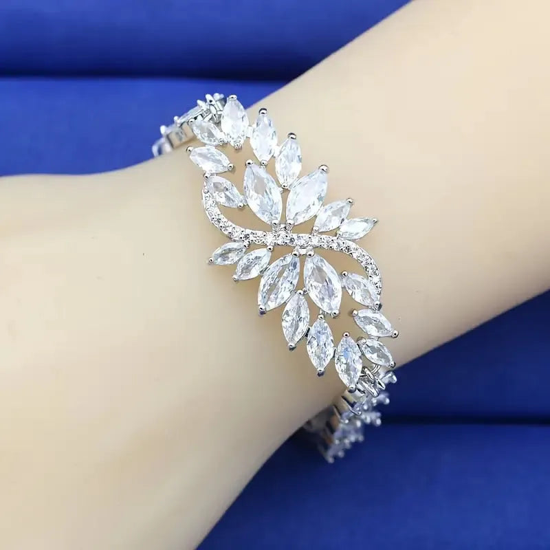 Gold electroplated copper bracelet with ice flower design and blue zircon stones