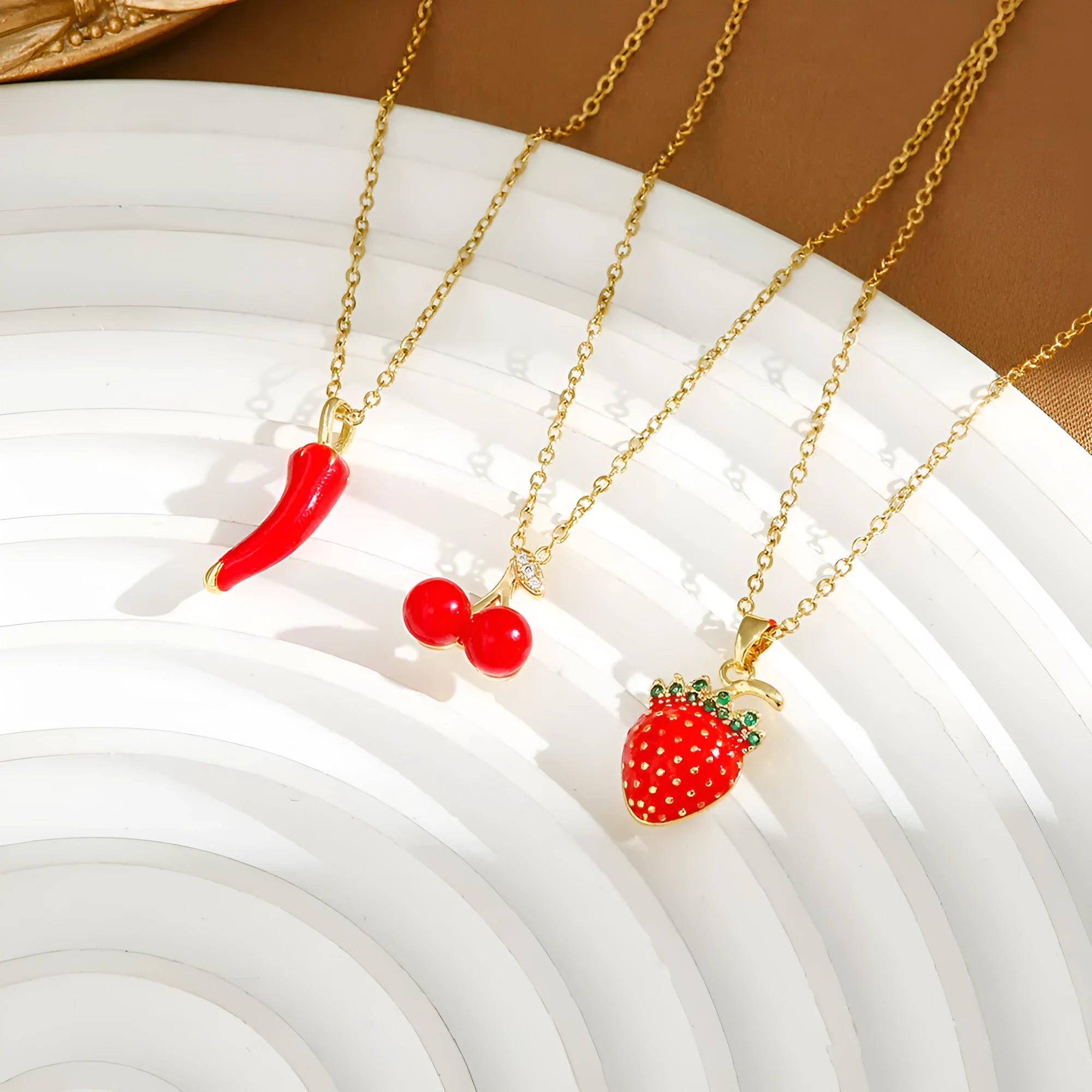 Red titanium steel necklace with a delicate alloy pendant shaped like cherries, strawberries, and peppers on an O-ring chain.