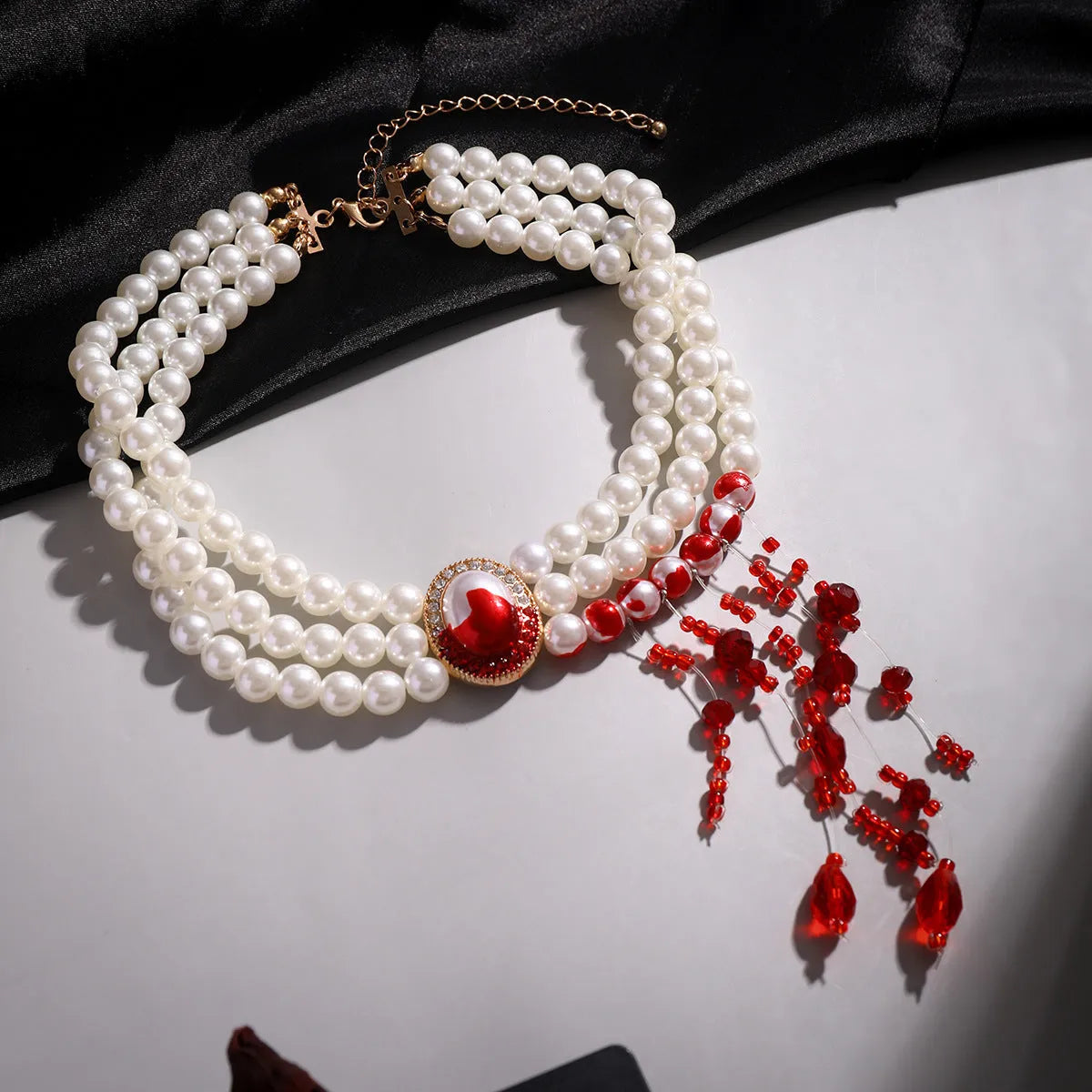 Gold tone gothic pearl collar jewellery set with U-shaped necklace, bracelet, and stud earrings.