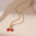A stainless steel necklace with a strawberry fruit pendant in either red or white gradient colour.