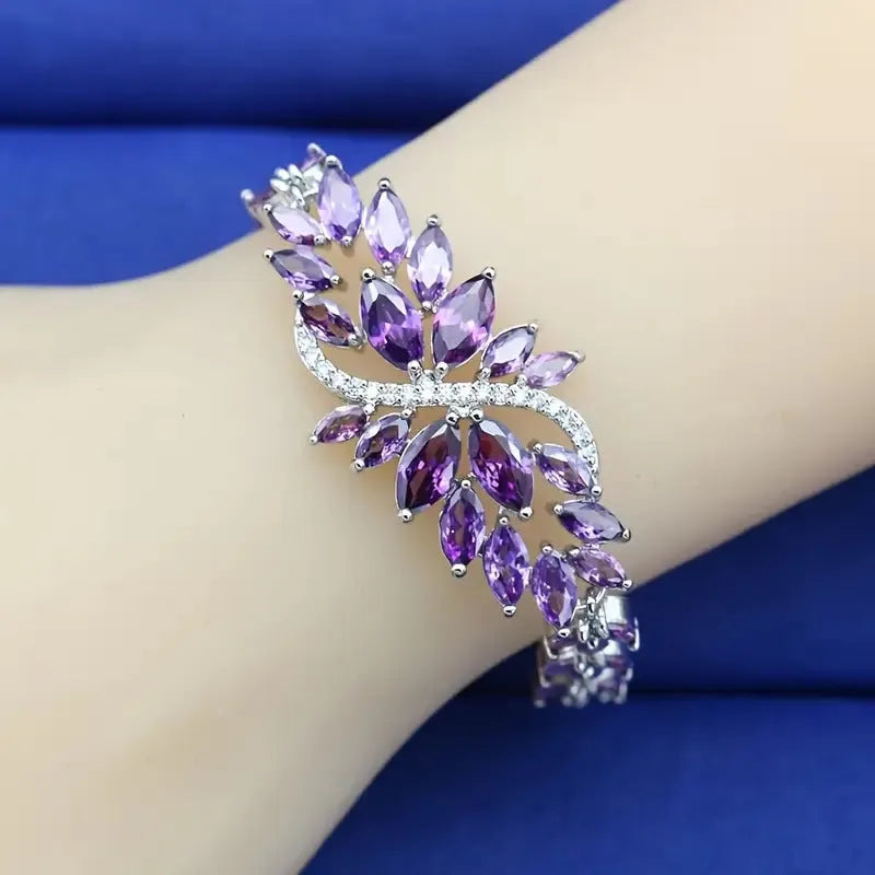 Gold electroplated copper bracelet with ice flower design and blue zircon stones
