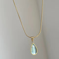 Retro blue and green water drop necklace with mixed gem inlay on a titanium steel snake bones chain.