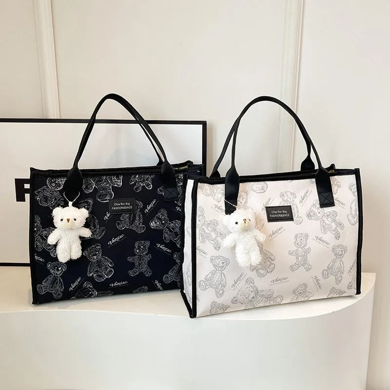 Women's black canvas tote bag with rhombus pattern and horizontal square design