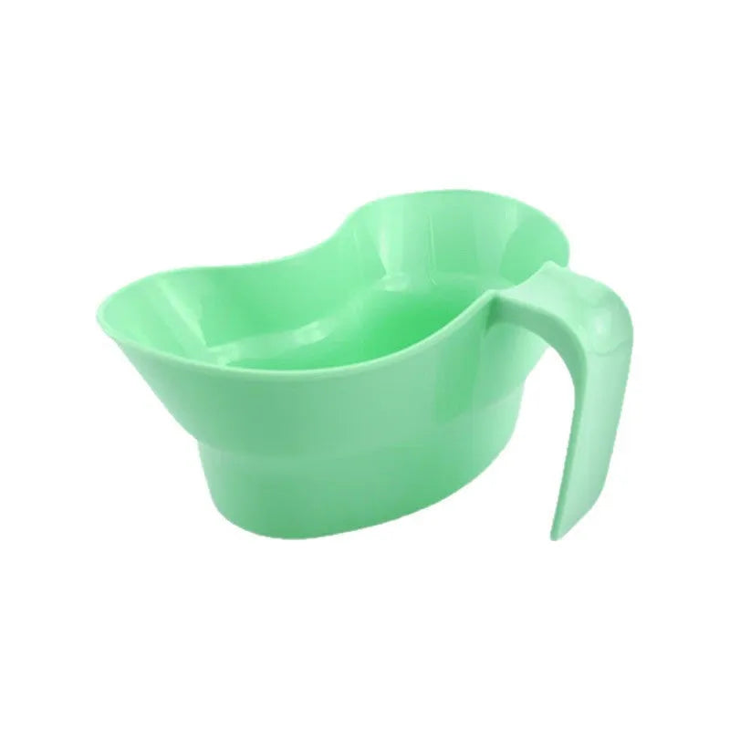 Green plastic gargle cup for bedridden elderly oral care.