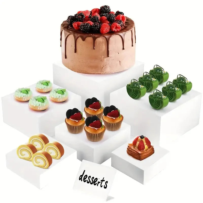 White plastic stacking cube dessert display stand set arranged in a pyramid for cakes and cupcakes.