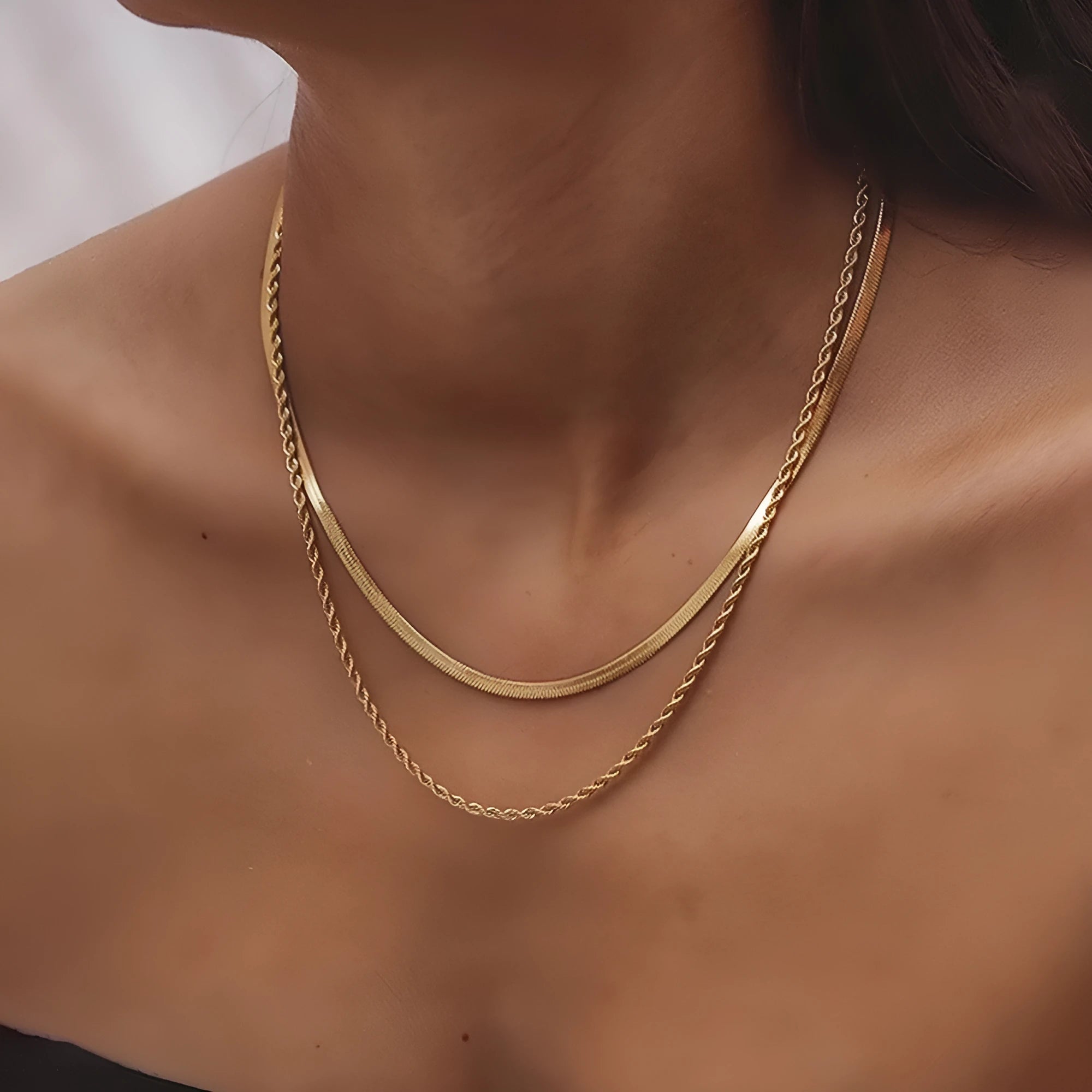 Women's silver geometric pendant necklace with an adjustable double-layer twist chain on a grey background.