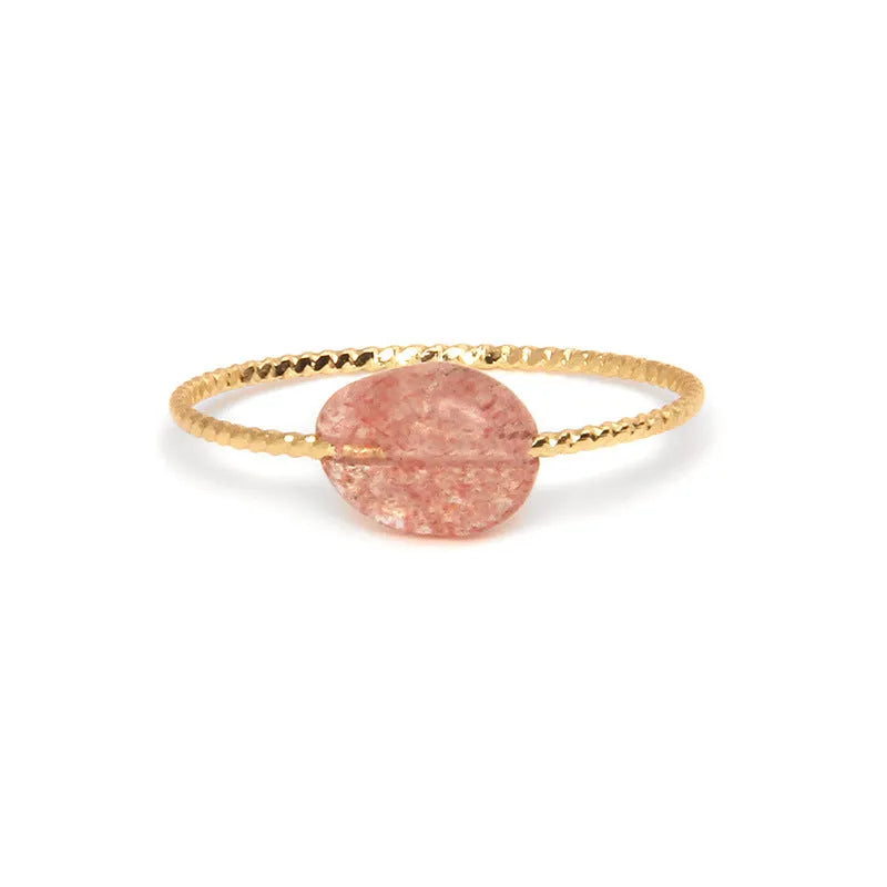 Women's geometric ring made from colourful agate stone on a neutral background.