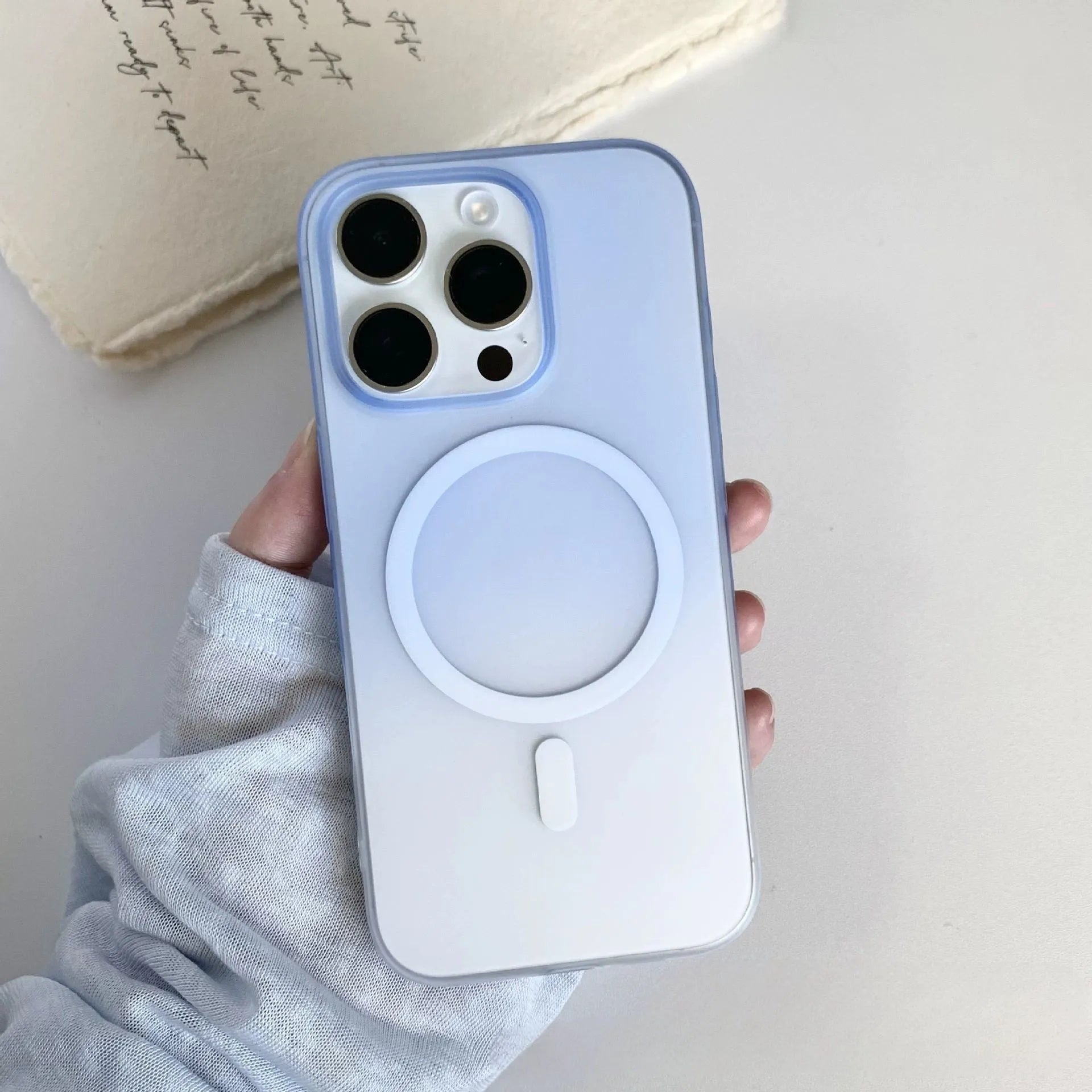 Gradient coloured frosted magnetic suction case for iPhone on a table
