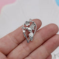 Close-up of a silver-grey alloy magpie pendant charm for DIY jewellery making on a white background.