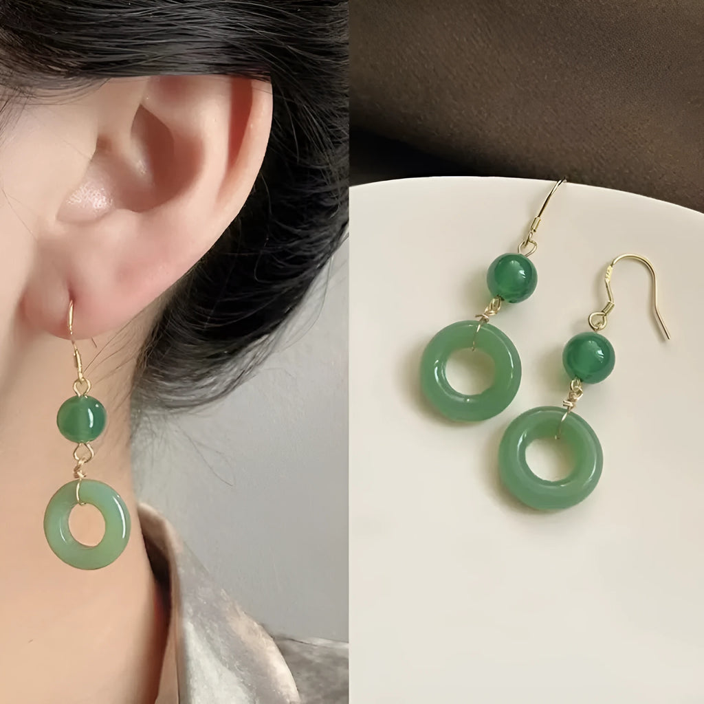 A pair of geometric peace buckle earrings with a green jade design and gold plating.