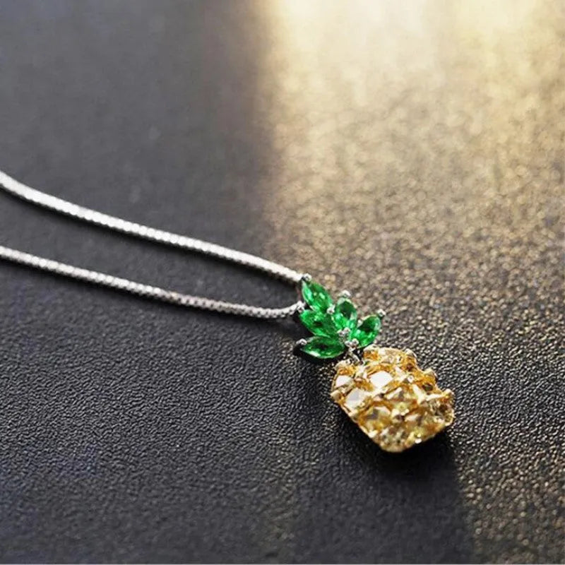 Silver plated women's necklace with a geometric pineapple pendant and diamond charm.