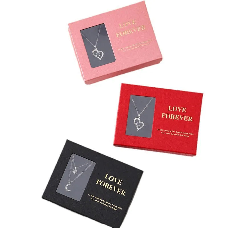 Red Korean-style gift box open to show six pink soap flowers, with a matching red handbag beside it.
