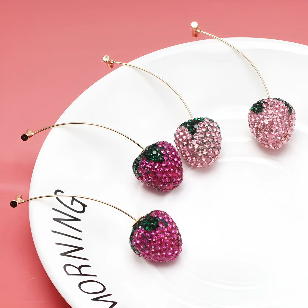 Pair of geometric strawberry stud earrings with spot drill texture in red zinc alloy, shown from front.