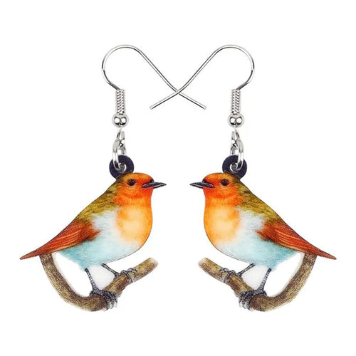 A pair of blue titmouse pendant earrings with printed design on acrylic, featuring geometric and snake elements.