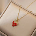 Red titanium steel necklace with a delicate alloy pendant shaped like cherries, strawberries, and peppers on an O-ring chain.
