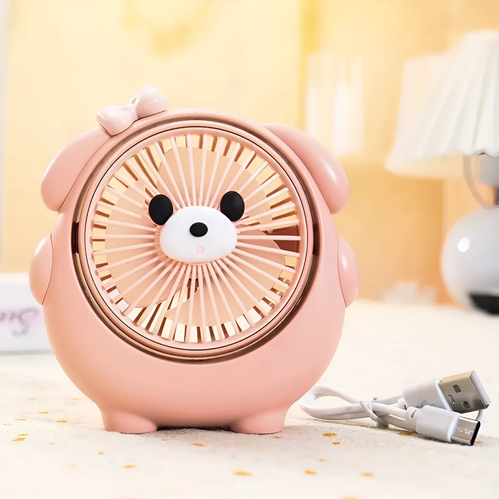 Cute dog-themed USB desktop electric fan in apricot puppy colour on a wooden desk.