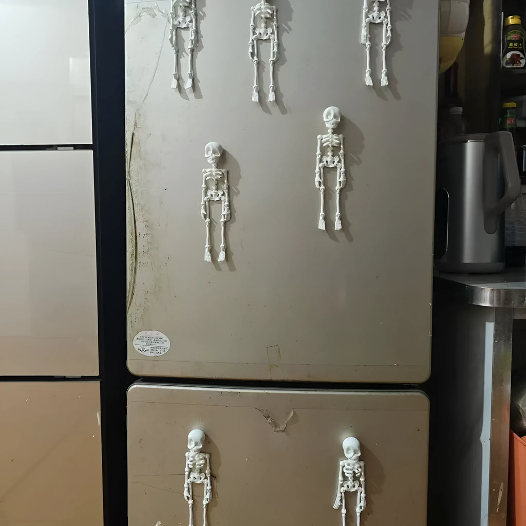 3D printed white skull refrigerator magnet on a metal surface, showing its 18cm height.