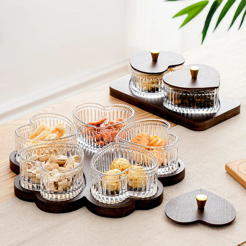 Glass fruit and snacks serving platter with multiple compartments and transparent heart-shaped lids in a retro style.