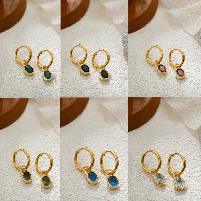 Close-up of a women's retro-style oval zircon earring in copper, showing elliptical stone setting and textured metal finish.
