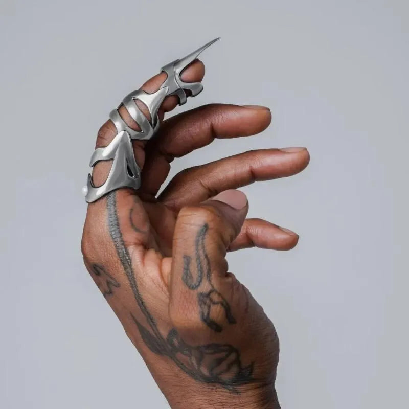 Silver-coloured alloy punk armour finger stall fashion ring.
