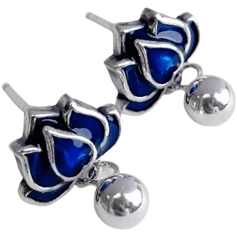 Blue lotus and seedpod earrings with dangling tassels on silver alloy posts.