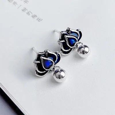 Blue lotus and seedpod earrings with dangling tassels on silver alloy posts.