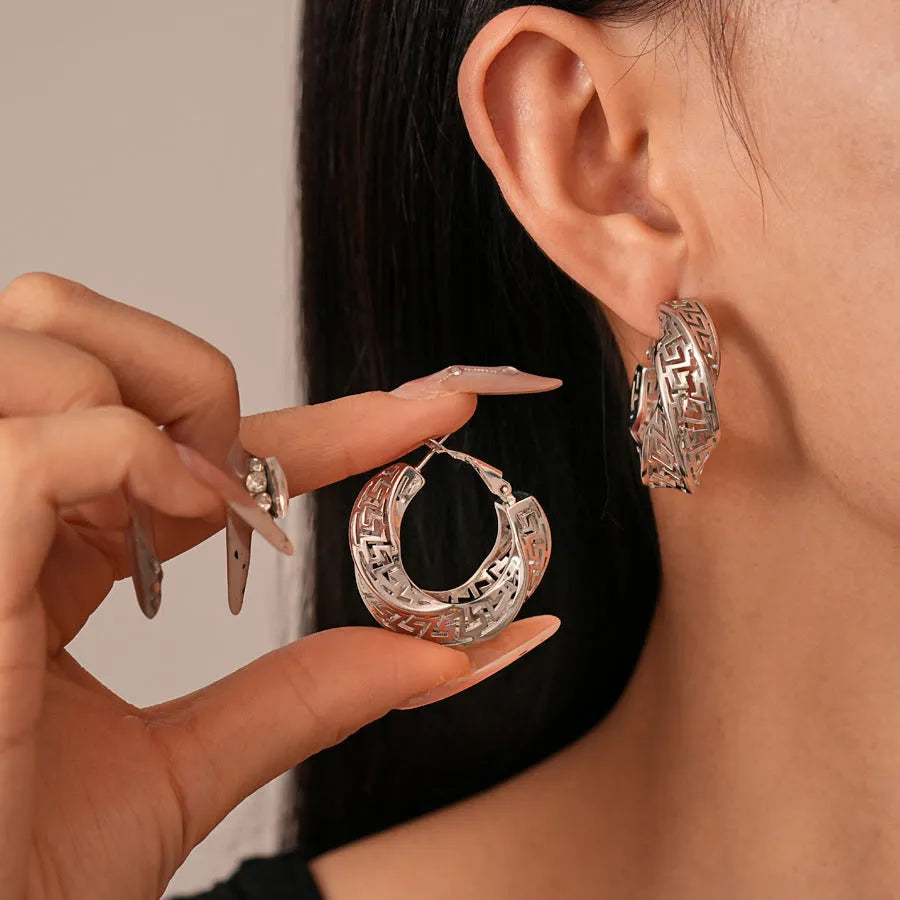Gold and silver geometric women's hollow stud earrings with a twisted round design