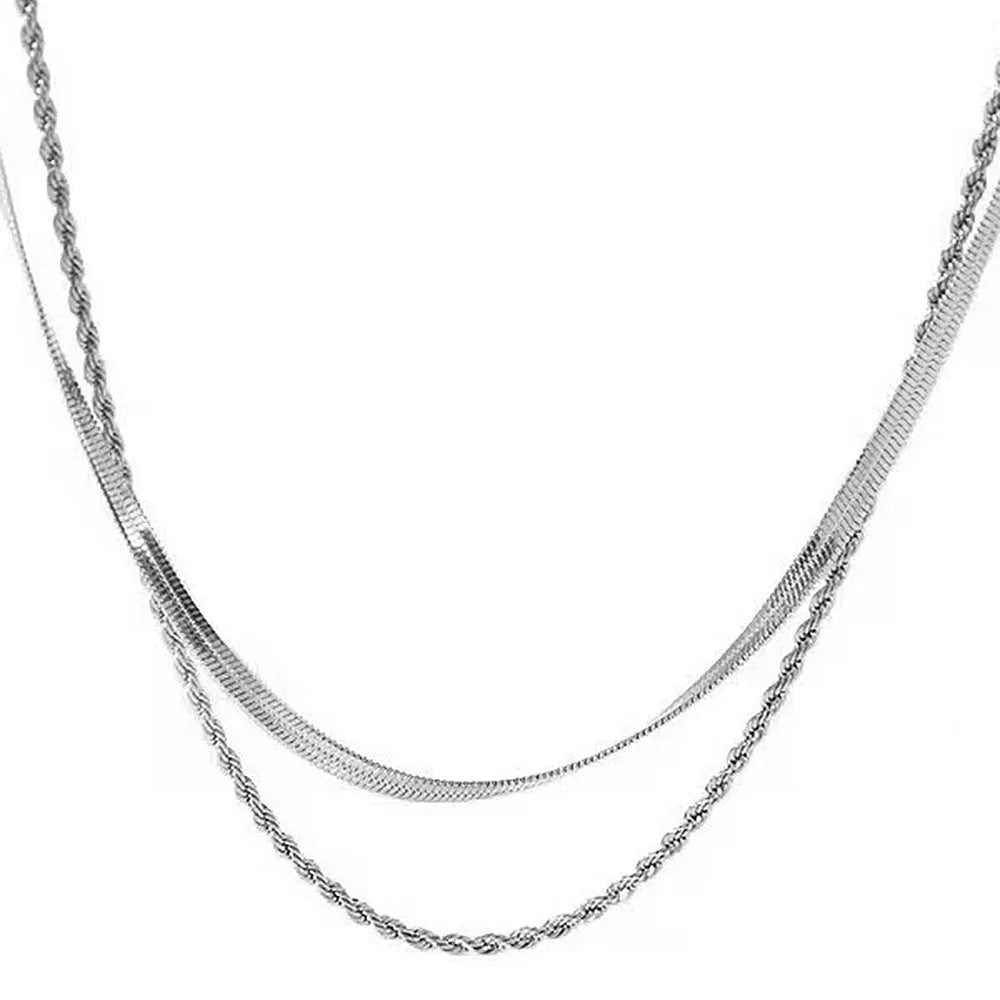 Women's silver geometric pendant necklace with an adjustable double-layer twist chain on a grey background.
