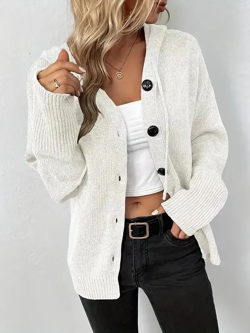 Man wearing a thick grey hooded cotton cardigan sweater with a loose fit.