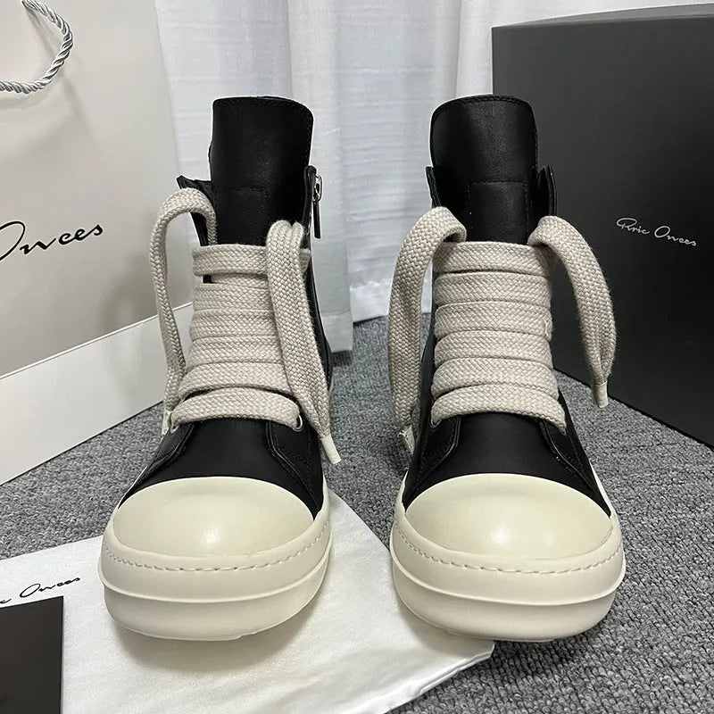 Black high-top leather boots with side zipper and round toe on a white background.