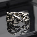 Copper men's ring with thorn flower design and adjustable geometric opening.