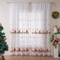Pair of red and white American Christmas curtains with embroidered snowflake design hung on a window.
