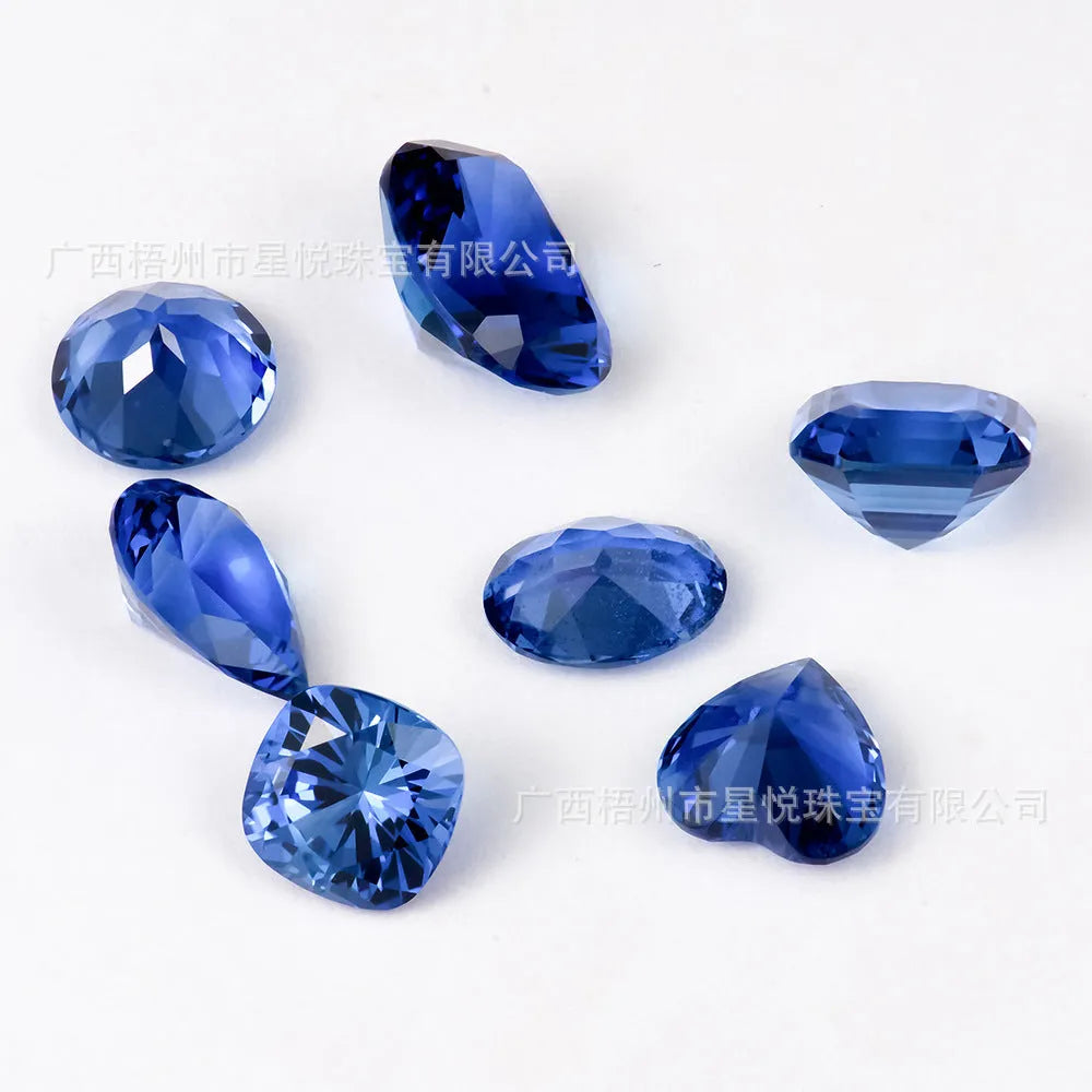 Loose blue heart-shaped cultivated sapphire gemstone on a jewellery cloth.