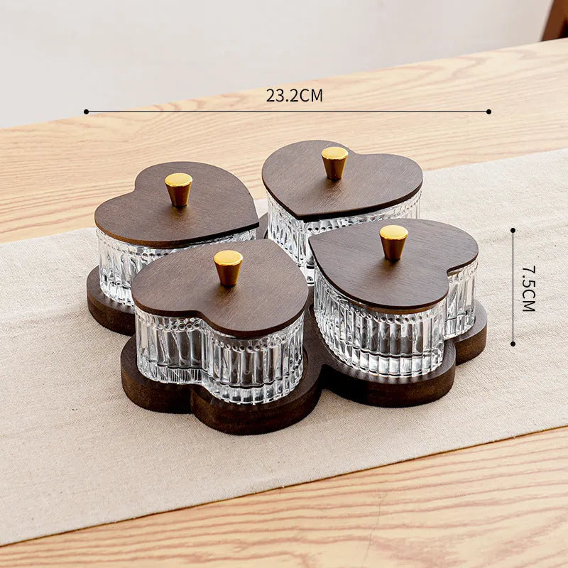 Glass fruit and snacks serving platter with multiple compartments and transparent heart-shaped lids in a retro style.
